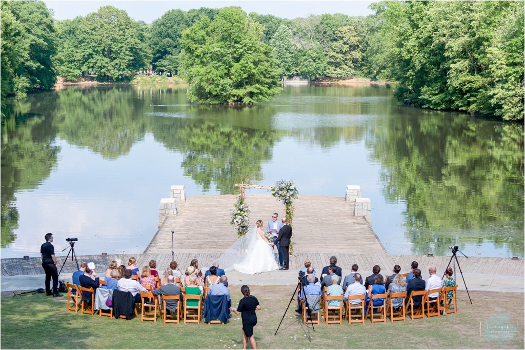 Wedding guests using handheld fans at an outdoor Florida ceremony