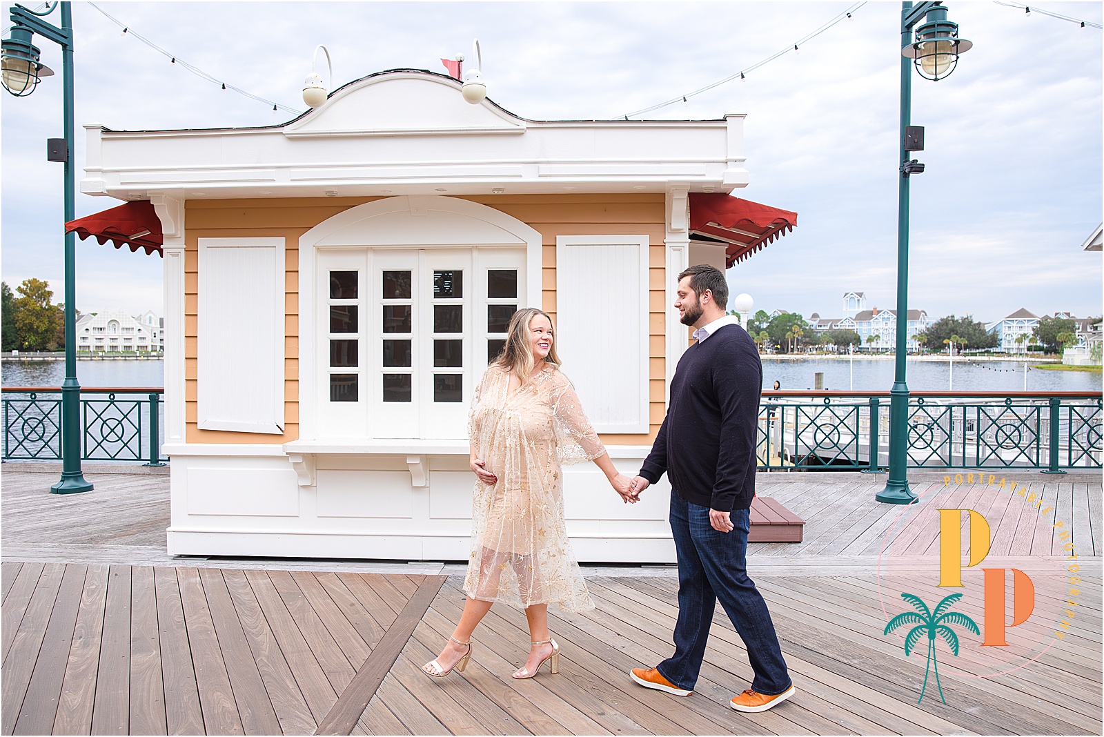 Capturing the beauty of pregnancy, this maternity portrait at Disney's BoardWalk Resort radiates warmth and happiness, as the mom-to-be embraces the magical surroundings.