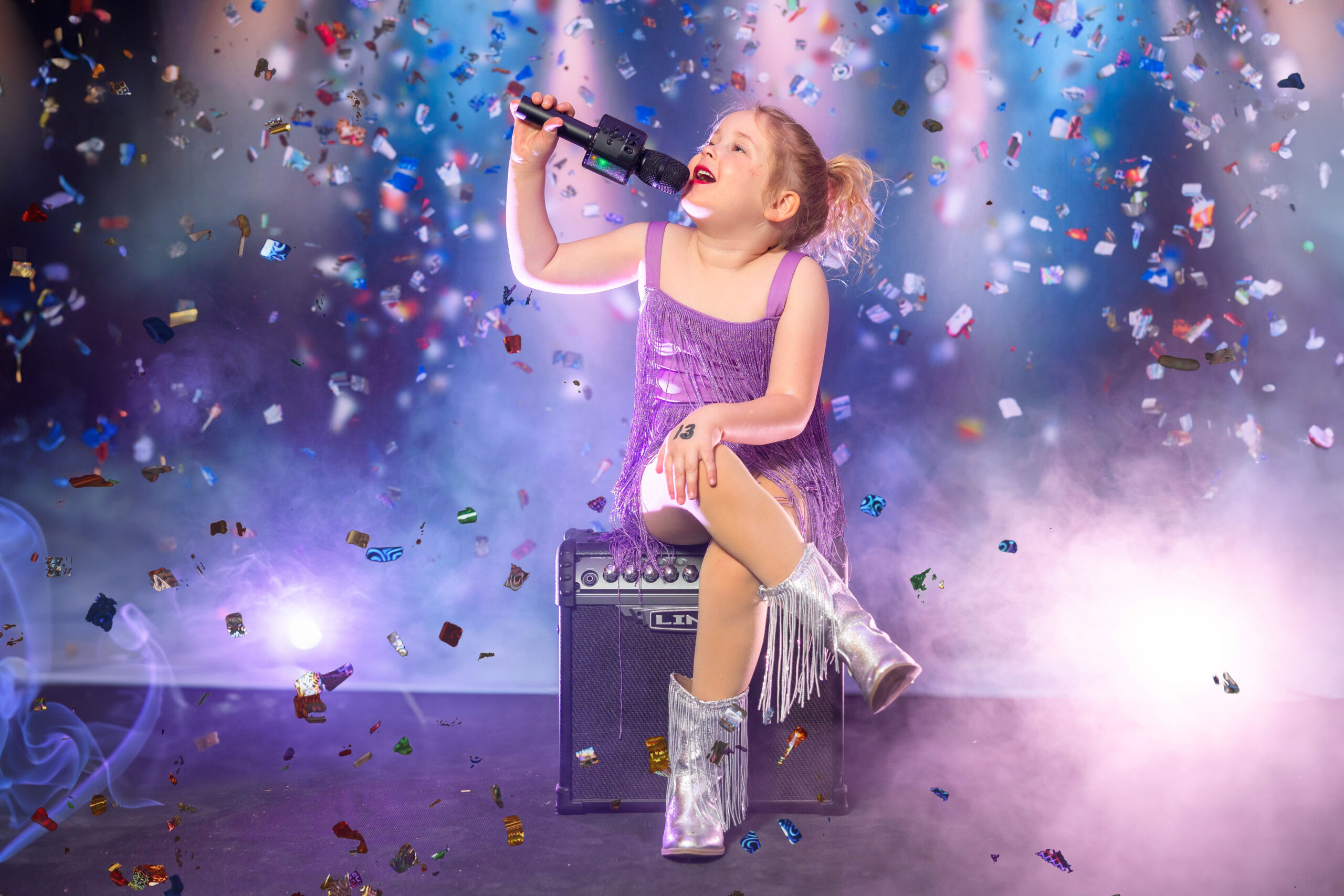 Close-up portrait of a child radiating confidence and star power in a Taylor Swift-themed mini session, capturing the essence of their inner superstar.