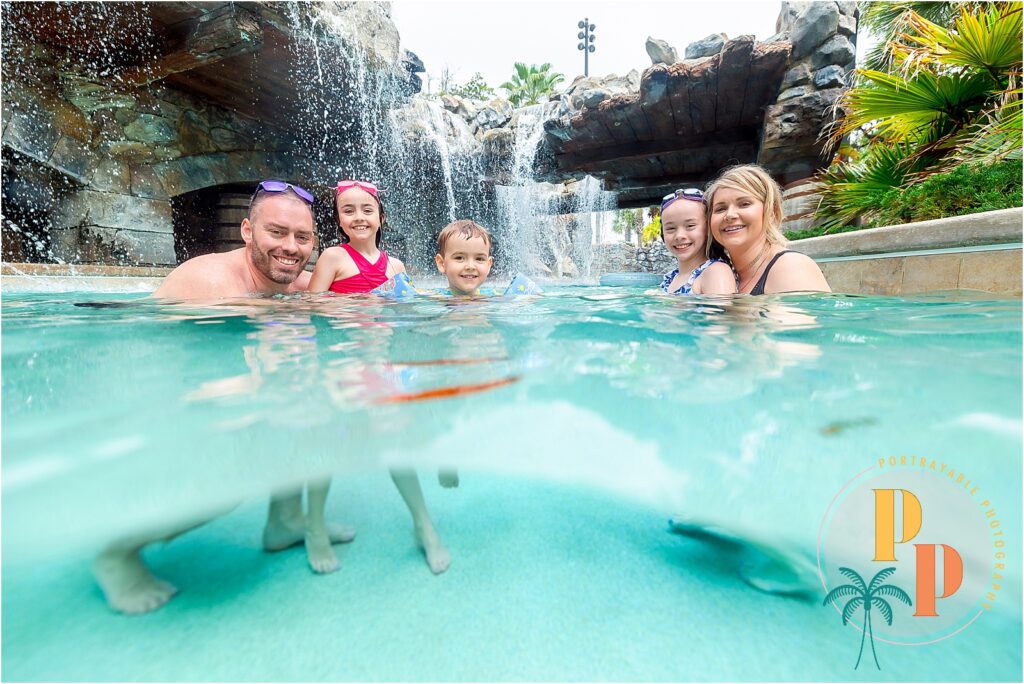 Family portrait underwater at Four Seasons Orlando.