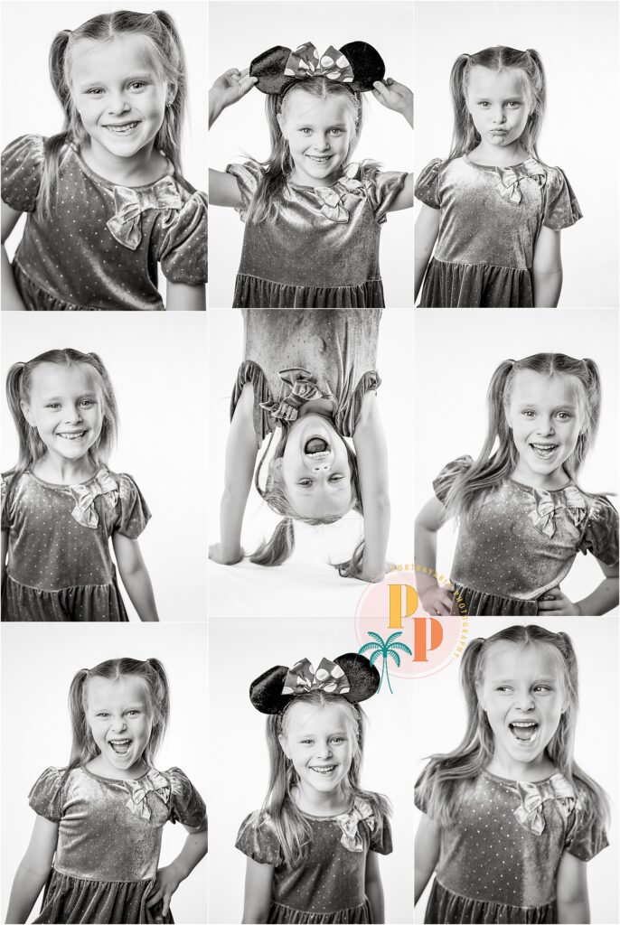 Black and white photo of a girl smiling confidently in front of a white backdrop.

