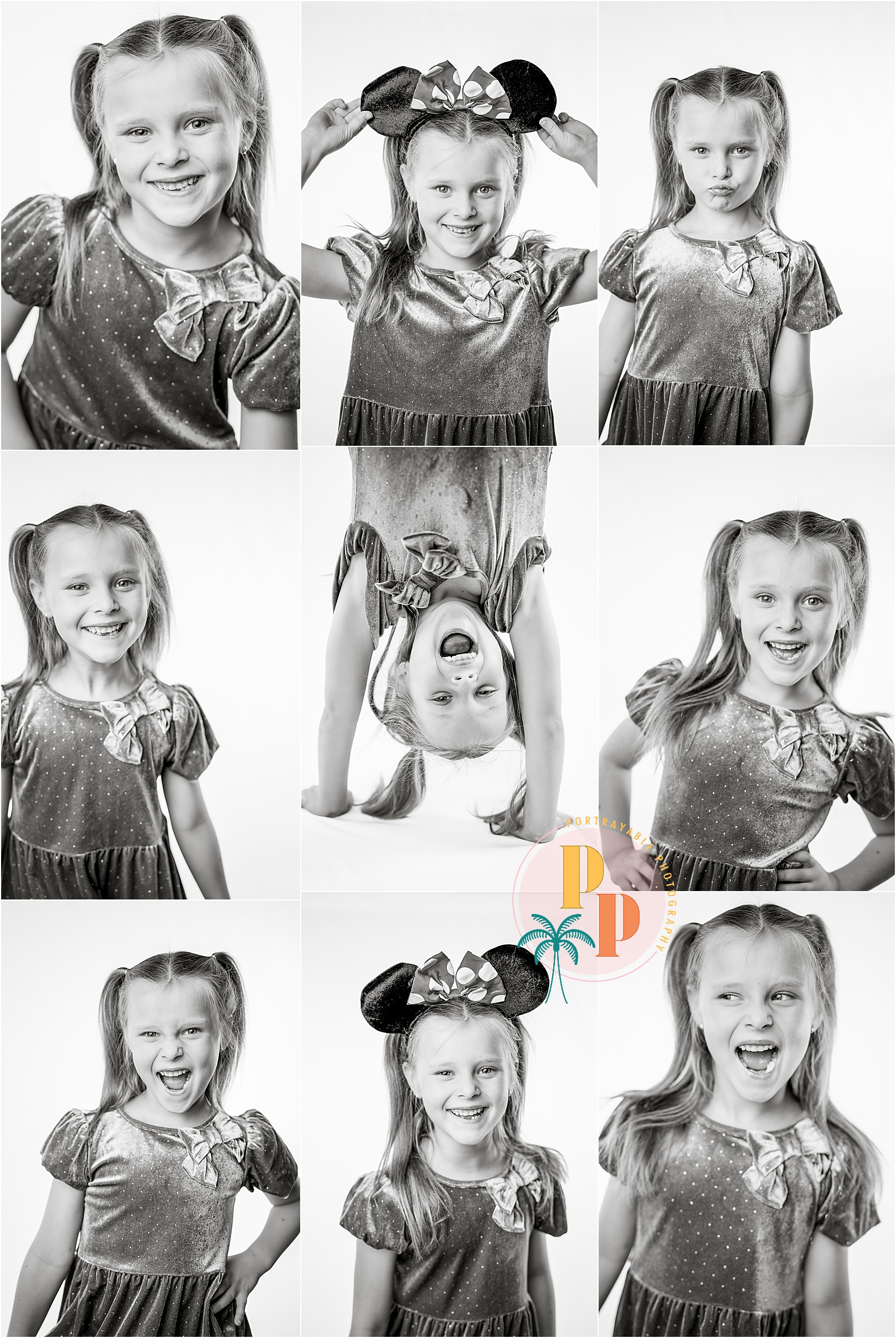 Black and white photo of a girl smiling confidently in front of a white backdrop.