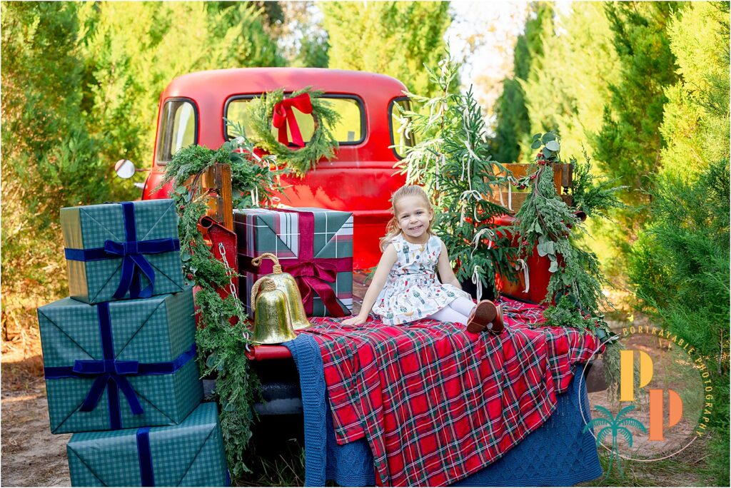 Festive truck with Christmas decorations and gifts.