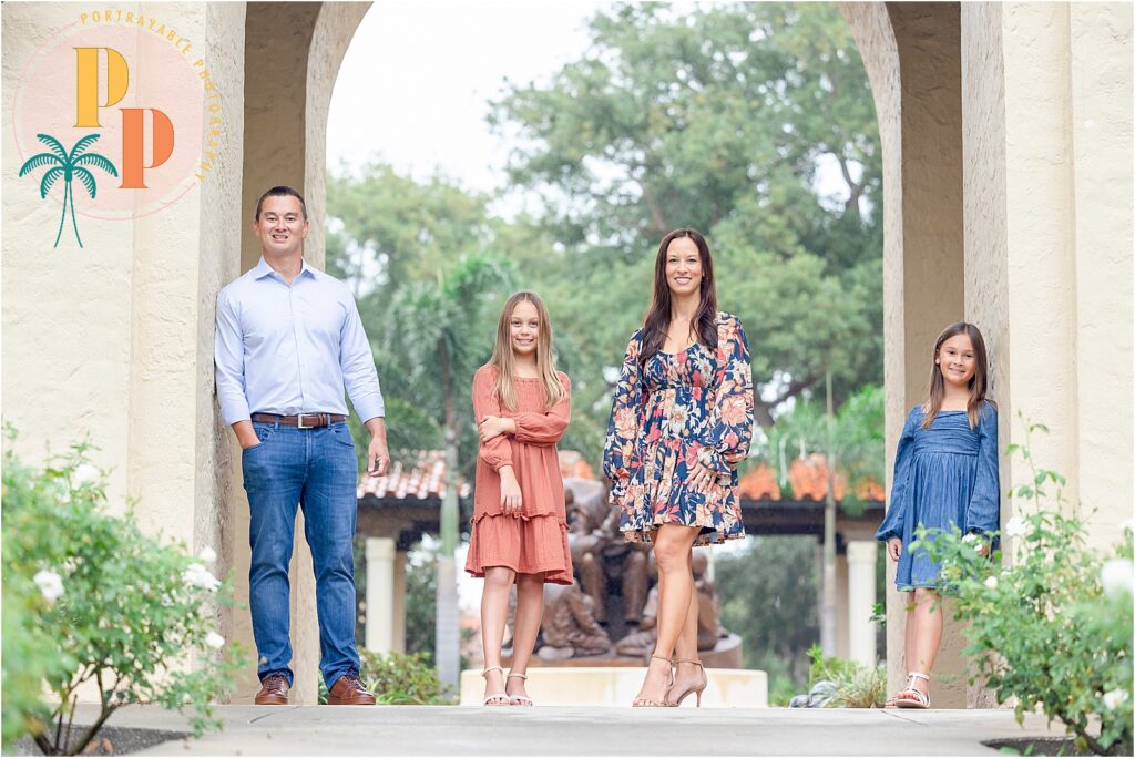 Family walking through beautiful archway at rollins college for their family shoot
