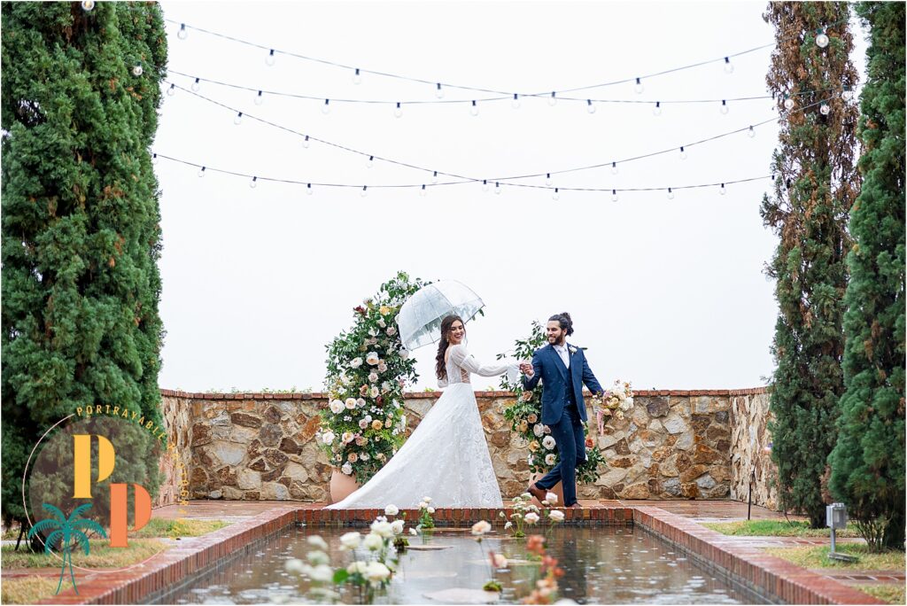 Bride and groom kissing after a summer rain storm at an Orlando wedding venue